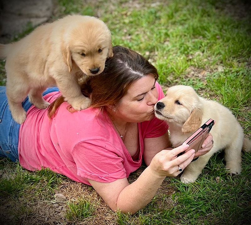 Jackie with two pups on the lawn